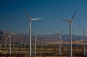 Wind turbines at sea with night sky and planet earth